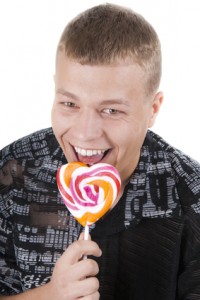 The young man is going to eat a lollypop